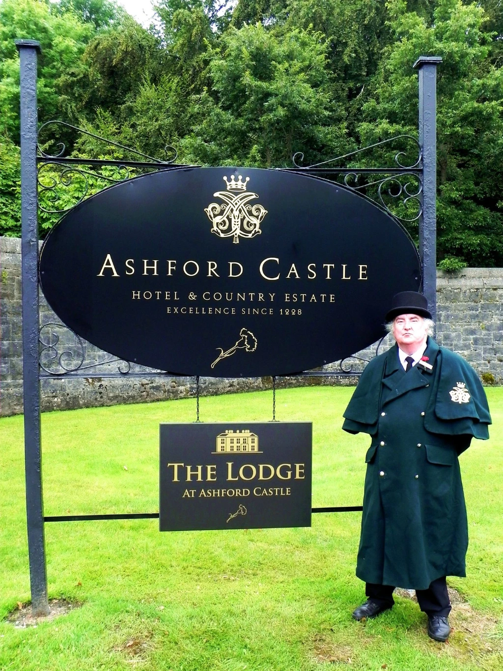 Pole-mounted hotel entrance signs with hotel doorman